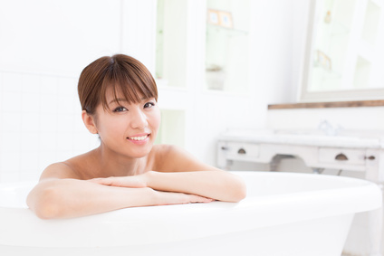 young asian woman relaxing in the bathroom